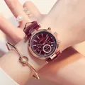 Close-up of a elegant burgundy leather strap watch with rose gold case worn on a model's wrist - Brown Leather Brown Dial
