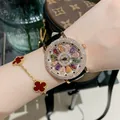 Montre de luxe pour femme avec lunette diamants et cadran fleuri rotatif coloré. - Rose Gold Case Multicolor Rhinestone Black Leather