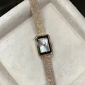 Close-up of GEDI square dial women's quartz watch featuring a textured rose gold strap - Rose Gold White