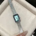 Close-up of GEDI square women's watch with silver textured strap in a velvet jewelry box. - Silver Green