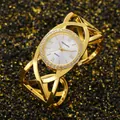 Detail of vintage round gold bracelet watch with crossed strap and crystal bezel - Gold White