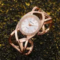 Close-up detail of a rose gold vintage bangle watch featuring a rhinestone bezel and dial. - Rose Gold