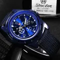 Detailed macro shot of a blue men's outdoor sports watch with a navy nylon canvas strap - Blue