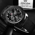 Detailed close-up of a men's sports watch featuring a black canvas strap and dial. - Black