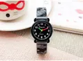 Close-up of a kids waterproof camouflage watch with grey silicone strap on a table - Gray Camouflage / Gray