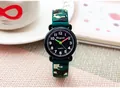 Close-up of children's camouflage watch with silicone strap on a lifestyle desk setting - Army Green Camo / Dark Green
