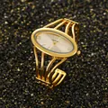 Elegant gold-tone quartz bangle watch with an oval dial and open cuff design. - Gold Gold Face