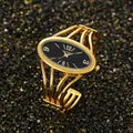 Elegant gold-tone bangle watch featuring a classic black oval dial for women - Gold Color Black