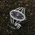 Detailed close-up of ogyawatch silver bangle watch with a sleek oval black dial face - Silver Band Black Dial