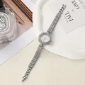 Close-up of elegant silver flower-shaped rhinestone ladies quartz watch on white tray - Silver