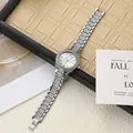 Detailed view of silver women's watch with sparkling rhinestones and steel band. - Silver