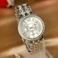 Macro view of silver Geneva watch with sparkling rhinestone bezel and detailed dial - Silver