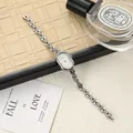 Detailed close-up of vintage oval silver bracelet watch for women with elegant metal strap - Oval Bracelet Style / Silver