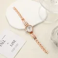 Detail view of a rose gold ladies' watch with rhinestone-studded lugs and steel band - Rose Gold