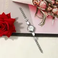 Detailed view of a silver-tone creative bracelet watch featuring elegant white enamel inserts - Silver Case White Dial