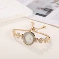 Elegant gold bracelet watch for women with sparkling flower-shaped rhinestone links - Gold