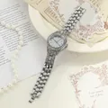 Detailed close-up of a silver-tone iced-out women's watch with rhinestone bezel - Silver