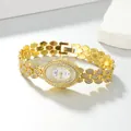 Close-up of elegant gold oval quartz bracelet watch with sparkling rhinestone inlay - Band: 21*1.2cm, Dial: 2.2*3cm / Gold