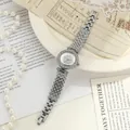 Close-up of elegant women's watch with full rhinestone crystals and vintage paper props - Silver