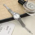 Detail view of fashionable ladies watch with Roman numerals and sparkling rhinestones - Silver
