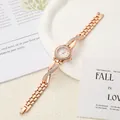 Elegant rose gold women's quartz watch featuring crystal-encrusted cross band design - Length 19.2cm Dial 2.2cm / Rose Gold