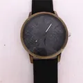 Close-up macro shot of a vintage bronze quartz watch featuring a textured blue denim pattern dial - Black