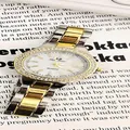 Close-up detail of iced-out gold quartz watch with diamond-encrusted bezel - Two-tone Gold and Silver