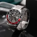 Close-up detail of a silver stainless steel quartz watch with calendar window and black-red bezel. - Black and Red Bezel