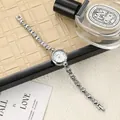 Detailed macro view of a silver ladies fashion watch with a sparkling rhinestone chain strap - Silver/White