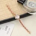 Elegant rose gold women's bracelet watch featuring pink crystal accents and heart-shaped links - Rose Gold Pink