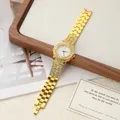 Close-up of a gold ladies quartz watch with rhinestone bezel and metal link bracelet. - Gold