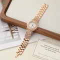 Elegant rose gold women's quartz watch with rhinestone bezel and strap on a wooden tray - Rose Gold