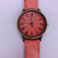 Vintage style bronze quartz watch with a peach pink denim texture dial and matching strap - Pink