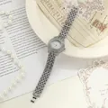 Detailed view of elegant silver women's quartz watch with sparkling rhinestone band - Silver