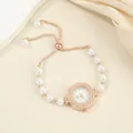 Close-up detail of luxury rose gold pearl bracelet watch with shimmering crystal dial - Round Style