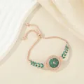 Elegant women's rose gold bracelet watch with green leaf crystals and small dial - Green