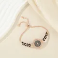 Rose gold women's bracelet watch with small rhinestone dial and black leaf pattern - Black