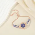 Elegant rose gold bracelet watch with blue leaf-shaped stones and adjustable drawstring strap - Blue