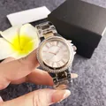 Close-up of elegant women's watch with Roman numerals and diamond bezel on wrist - Two-tone Rose Gold