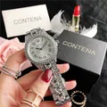 Close-up detail of luxury silver rhinestone watch with Roman numeral dial. - Silver