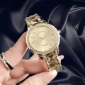 Close-up of elegant gold women's watch featuring crystal bezel and faceted geometric strap - Gold