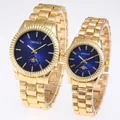 Detail view of gold-tone couple quartz watches with dark blue dials and steel bands - Female Style / Gold Blue Face
