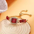 Detail of luxury square quartz watch with red dial and crystal-embellished bezel on wood - Red