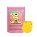 Close-up of yellow textured turmeric cleansing pads shown with pink skincare pouch - 40-Count Bagged Cleansing Pads