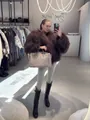 Stylish woman wearing an oversized brown curly faux sheep fur coat in a boutique mirror - S / Tops / Dark Brown