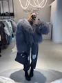 Close-up of grey long-haired faux fur jacket shown in a boutique mirror selfie - S / Tops / Light Gray