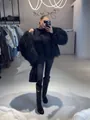 Elegant oversized black shaggy faux fur jacket with fluffy wool texture for winter - Black