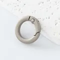 Close-up of circular matte gunmetal spring ring clasp for DIY jewelry and keychains - Spring Ring
