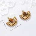 Macro view of tiger's eye pendants with 18K gold plating showing size and weight specs - Spiked Edge Oval Style
