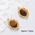 Close-up of 18K gold plated tiger eye stone pendant with measurements 15mm by 10.7mm - Baroque Oval Style